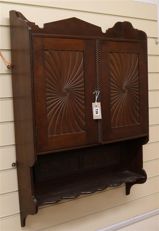A carved mahogany hanging wall cabinet W.64cm
